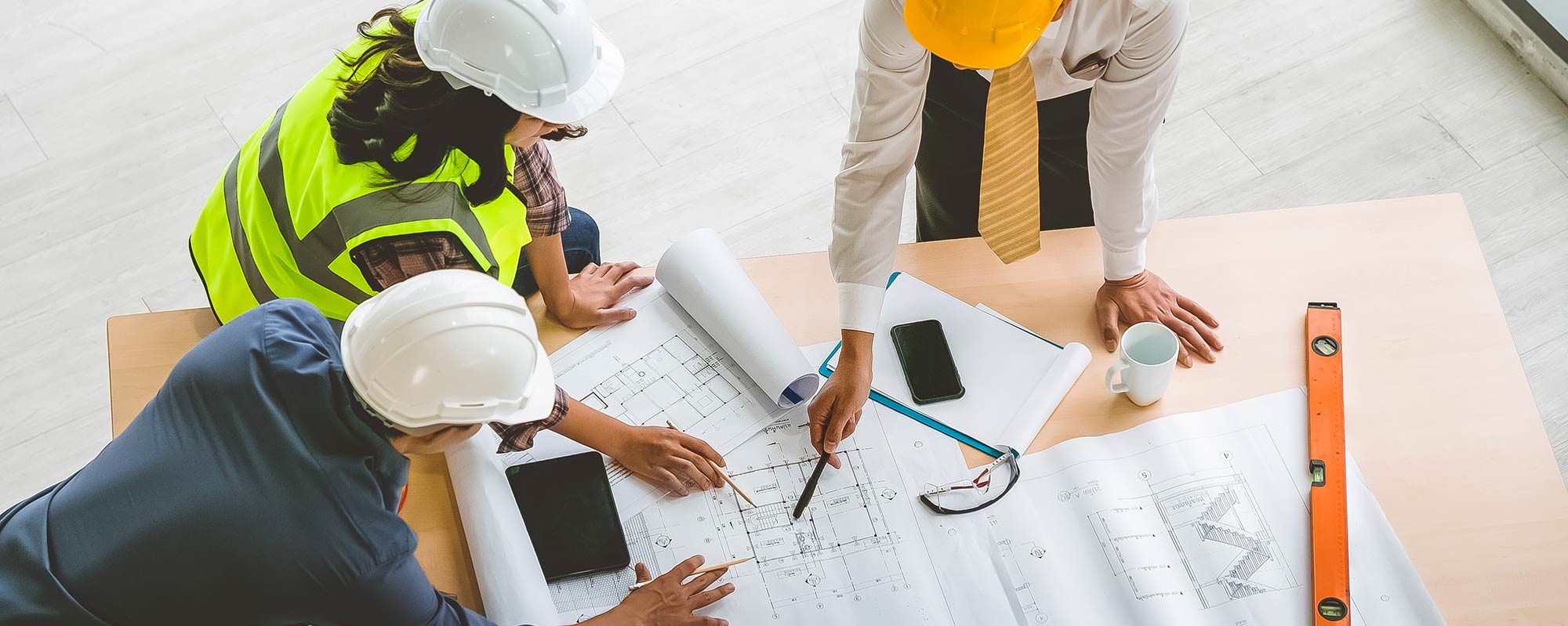 Technical professionals reviewing project drawings for green building, sustainability and building certification services