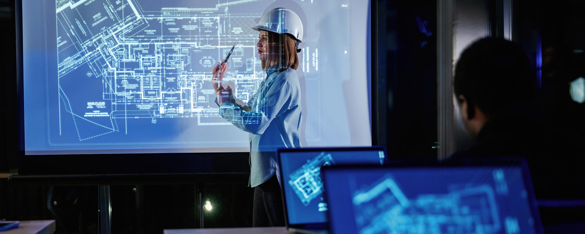 Technical professional reviewing digital project drawings for real estate due diligence, compliance and technical assessment services